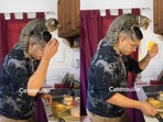 Cat cooking with a man. 