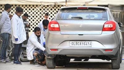 FSL officials inspect the Maruti Suzuki Baleno that dragged Anjali Kumari for three hours over 13km in January. (HT Archive)