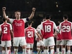 Arsenal's Martin Odegaard celebrates after scoring during the Group B Champion League soccer match, between Arsenal and PSV Eindhoven at the Emirates Stadium in London