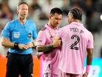 Inter Miami forward Lionel Messi (10) places the captain's armband on defender DeAndre Yedlin (2) during the first half