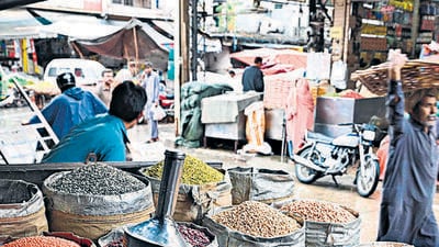 A shopkeeper selling pulses waits for customers at a market in Rawalpindi on June 1, 2023. (Photo by Farooq NAEEM / AFP) (AFP) A shopkeeper selling pulses waits for customers at a market in Rawalpindi on June 1, 2023. (Photo by Farooq NAEEM / AFP) (AFP)