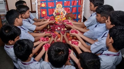 Students offer flower petals to Lord Ganesha as they celebrate Ganesh Chaturthi festival at Gyanganga Vidyalaya in Surat. (ANI) Students offer flower petals to Lord Ganesha as they celebrate Ganesh Chaturthi festival at Gyanganga Vidyalaya in Surat. (ANI)
