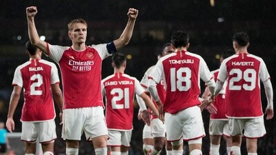 Arsenal's Martin Odegaard celebrates after scoring during the Group B Champion League soccer match, between Arsenal and PSV Eindhoven at the Emirates Stadium in London (AP)