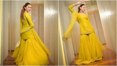 Rakul Preet Singh chose a yellow gharara suit set for the Ganesh Chaturthi bash. The outfit is from the shelves of the clothing label Jigar Mali. It features a short kurti, tulle gharara pants, and an embroidered net dupatta. The kurta features a scalloped hem, intricate gold work, full-length sleeves, a U neckline, and a form-fitting silhouette. (Instagram) Rakul Preet Singh chose a yellow gharara suit set for the Ganesh Chaturthi bash. The outfit is from the shelves of the clothing label Jigar Mali. It features a short kurti, tulle gharara pants, and an embroidered net dupatta. The kurta features a scalloped hem, intricate gold work, full-length sleeves, a U neckline, and a form-fitting silhouette. (Instagram)