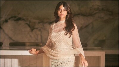 Suhana styled the sleeveless kurta with cream-coloured silk chutidar pants and a net dupatta. She draped the see-through on her shoulder. It features sequin embroidery, pearl tassel embellishments on the hem, and patti embroidery on the borders. (Instagram) Suhana styled the sleeveless kurta with cream-coloured silk chutidar pants and a net dupatta. She draped the see-through on her shoulder. It features sequin embroidery, pearl tassel embellishments on the hem, and patti embroidery on the borders. (Instagram)