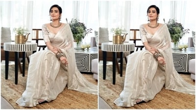 Karishma looked like a dream in an ivory white silk saree and teamed it with a matching blouse featuring long sleeves and a sweetheart neckline.&nbsp; (Instagram/@karishmaktanna)