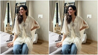 Karishma's kurta featured minimal patterns in silver embellishments and long sleeves. Giving it a breezy feel, she teamed it with classic blue denims.&nbsp; (Instagram/@karishmaktanna)
