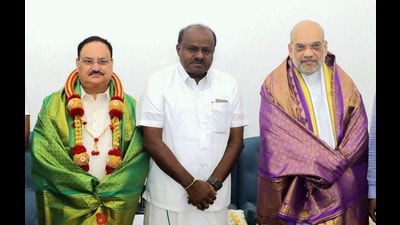 Union Home Minister Amit Shah and BJP National President JP Nadda with former Karnataka chief minister HD Kumaraswamy durig a meeting, in New Delhi on Friday. (PTI)