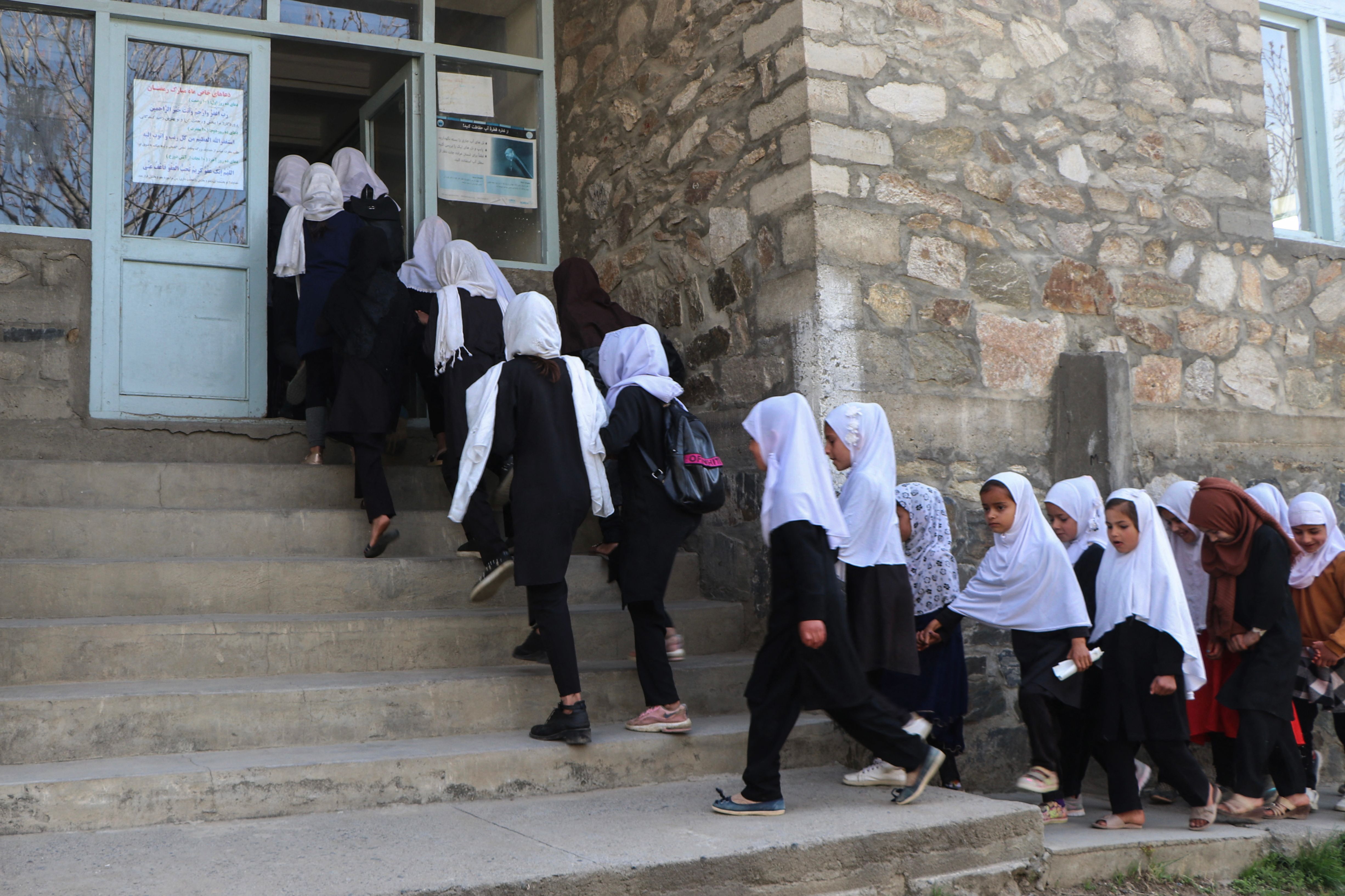 Children, in queue, seen walking to school. (AFP ) Children, in queue, seen walking to school. (AFP )