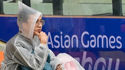 A spectator sits in the stands during a rain delay at the 2022 Asian Games in Hangzhou in China's eastern Zhejiang province (AFP) A spectator sits in the stands during a rain delay at the 2022 Asian Games in Hangzhou in China's eastern Zhejiang province (AFP)