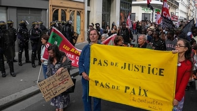 People march with a banner that reads, "no justice, no peace," in Paris. (AP) People march with a banner that reads, "no justice, no peace," in Paris. (AP)