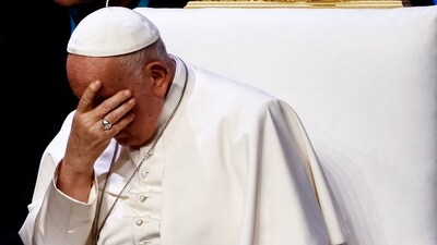 Pope Francis reacts as he attends a meeting at Palais du Pharo. (Reuters)