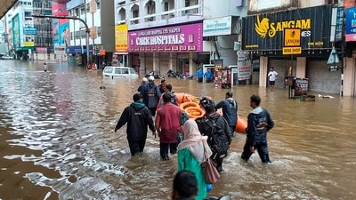 Rescue team officials wade through a waterlogged road during rescue operation after heavy rains lashed the city, inundating low-lying areas and triggering measures to shift people from these pockets to safer places in Nagpur. (PTI) Rescue team officials wade through a waterlogged road during rescue operation after heavy rains lashed the city, inundating low-lying areas and triggering measures to shift people from these pockets to safer places in Nagpur. (PTI)
