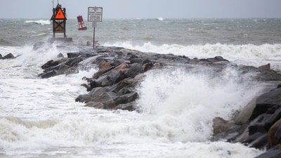Tropical Storm Ophelia: Waves break along the jetty at Rudee Inlet in Virginia Beach, as Tropical Storm Ophelia approaches the area. (AP)