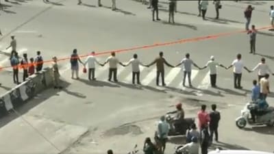 Protestors formed human chains in protest of release of Cauvery water to Tamil Nadu. (ANI) Protestors formed human chains in protest of release of Cauvery water to Tamil Nadu. (ANI)