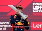 Red Bull's Max Verstappen celebrates with a trophy on the podium after winning the Japanese Grand Prix