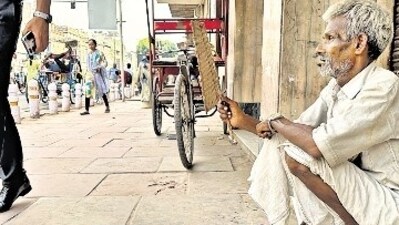 Shyamdev sits on a Daryaganj pavement, charging passers-by for “weight checks”. Shyamdev sits on a Daryaganj pavement, charging passers-by for “weight checks”.