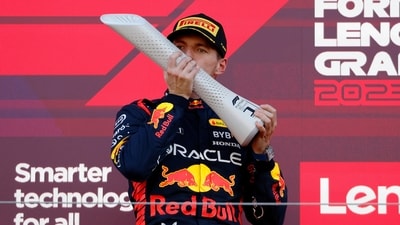 Red Bull's Max Verstappen celebrates with a trophy on the podium after winning the Japanese Grand Prix (REUTERS)