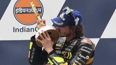 Mooney VR46 Racing Team's Marco Bezzecchi celebrates with the trophy on the podium after winning the MotoGP (REUTERS)