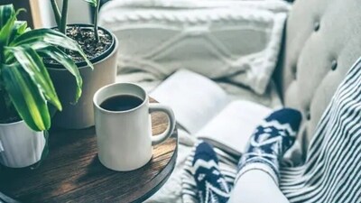 The joy of doing nothing and just watching the world go on by the window with a hot cup of flavoured coffee in hand can help us to enjoy the onset of the winter season.&nbsp; (Unsplash)