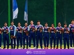 The Indian women's cricket squad on the podium with their gold medals after making history.(Getty)
