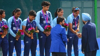 The Indian women cricket team with their gold medals on the podium during the post-match presentation after the finals of Asian Games Women's T20I in Hangzhou The Indian women cricket team with their gold medals on the podium during the post-match presentation after the finals of Asian Games Women's T20I in Hangzhou