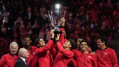 Team World's Taylor Fritz, center left, and Ben Shelton, center right, hoist the Laver Cup in front of their teammates, John McEnroe, back left, and Rod Laver, front left, after Team World defeated Team Europe (AP) Team World's Taylor Fritz, center left, and Ben Shelton, center right, hoist the Laver Cup in front of their teammates, John McEnroe, back left, and Rod Laver, front left, after Team World defeated Team Europe (AP)