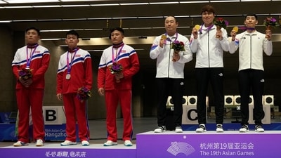 Gold medalists team South Korea, right, and silver medalists team North Korea pose during the awards ceremony of team men's 25-meter rapid fire pistol shooting at the Fuyang Yinhu Sports Centre in the 19th Asian Games in Hangzhou (AP) Gold medalists team South Korea, right, and silver medalists team North Korea pose during the awards ceremony of team men's 25-meter rapid fire pistol shooting at the Fuyang Yinhu Sports Centre in the 19th Asian Games in Hangzhou (AP)