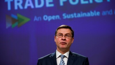 European Commissioner for An Economy that Works for the People, Valdis Dombrovskis, looks on. (Reuters)