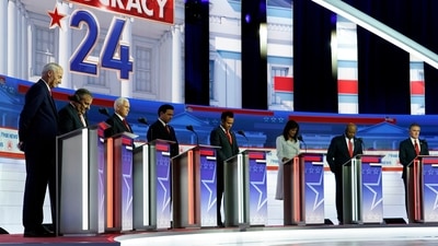FILE - Republican presidential candidates, from left, former Arkansas Gov. Asa Hutchinson, former New Jersey Gov. Chris Christie, former Vice President Mike Pence, Florida Gov. Ron DeSantis, businessman Vivek Ramaswamy, former U.N. Ambassador Nikki Haley, Sen. Tim Scott, R-S.C., and North Dakota Gov. Doug Burgum stand on stage and listen to a prayer before a Republican presidential primary debate hosted by FOX News Channel, Wednesday, Aug. 23, 2023, in Milwaukee. (AP) FILE - Republican presidential candidates, from left, former Arkansas Gov. Asa Hutchinson, former New Jersey Gov. Chris Christie, former Vice President Mike Pence, Florida Gov. Ron DeSantis, businessman Vivek Ramaswamy, former U.N. Ambassador Nikki Haley, Sen. Tim Scott, R-S.C., and North Dakota Gov. Doug Burgum stand on stage and listen to a prayer before a Republican presidential primary debate hosted by FOX News Channel, Wednesday, Aug. 23, 2023, in Milwaukee. (AP)