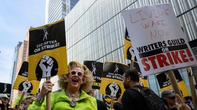 Actors, writers and other union members join SAG-AFTRA and WGA strikers on a picket line in front of the offices of HBO and Amazon. (AFP/File) Actors, writers and other union members join SAG-AFTRA and WGA strikers on a picket line in front of the offices of HBO and Amazon. (AFP/File)