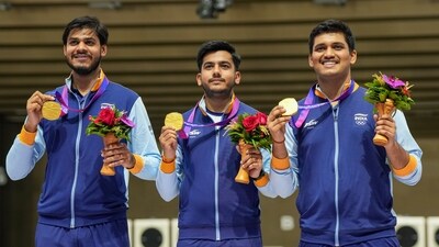 Indian shooters Rudrankksh Patil (right), Aishwary Pratap Singh Tomar (centre) and Divyansh Singh Panwar pose for photos with their gold medals during the presentation ceremony of Men's 10m Air Rifle team event at the 19th Asian Games (PTI) Indian shooters Rudrankksh Patil (right), Aishwary Pratap Singh Tomar (centre) and Divyansh Singh Panwar pose for photos with their gold medals during the presentation ceremony of Men's 10m Air Rifle team event at the 19th Asian Games (PTI)