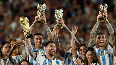 Argentina's Lionel Messi and teammates celebrate with their families and World Cup trophies (FILE) (REUTERS)