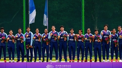 The Indian women's cricket squad on the podium with their gold medals after making history. (Getty) The Indian women's cricket squad on the podium with their gold medals after making history. (Getty)