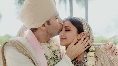 Parineeti Chopra and Raghav Chadha's wedding album featured another candid photo. Raghav, who wore an ivory sherwani set and matching turban, kissed his bride's forehead in the sweet picture. He also had an arm around Parineeti, who kept her eyes closed. Parineeti Chopra and Raghav Chadha's wedding album featured another candid photo. Raghav, who wore an ivory sherwani set and matching turban, kissed his bride's forehead in the sweet picture. He also had an arm around Parineeti, who kept her eyes closed. 