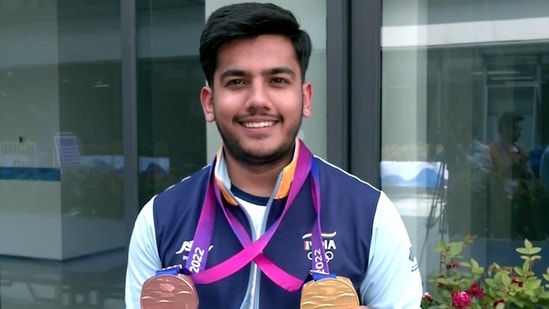 Aishwary Pratap Singh Tomar shows the Bronze and Gold medal he won in the finals of individual and team event of the Men's 10m air rifle at the Asian Games 2023(ANI)