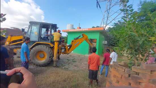 The local administration also demolished an allegedly illegal office of Bharatiya Janata Yuva Morcha that was constructed on illegally occupied land of the irrigation department. (HT)