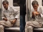 Elderly man smoking beedi inside Delhi Metro. Elderly man smoking beedi inside Delhi Metro.