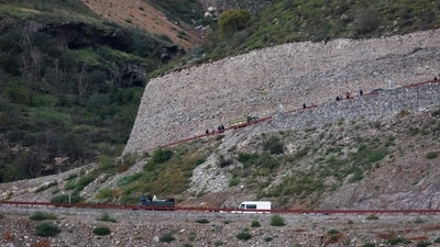 This photograph taken on September 26, 2023, from the Azerbaijan side of the border, shows people entering in Armenia after crossing the Lachin border. On September 26. (AFP)