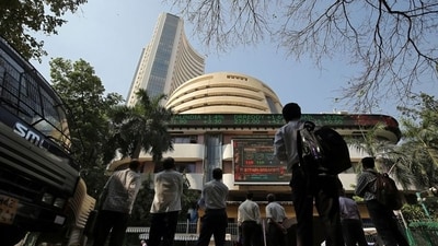 Share markets figures: People look at a screen displaying the Sensex results on the facade of the Bombay Stock Exchange (BSE) building in Mumbai. (REUTERS)