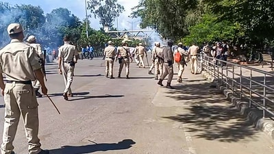 Imphal: Security personnel stand guard during a protest against the killing of two youths who were allegedly kidnapped in July, in Imphal, Tuesday, Sept. 26, 2023. More than 30 students, mostly girls, were injured after the police fired tear gas shells and baton-charged the protestors. (PTI Photo) (PTI09_26_2023_000378B)