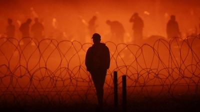 Migrants gather near the border wall after crossing the Rio Bravo (Source: Reuters) (REUTERS)