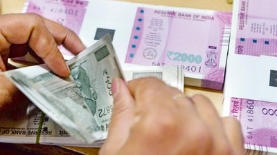 A bank staff member counts notes to give to customers. (AFP) A bank staff member counts notes to give to customers. (AFP)