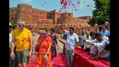 Flower petals being showered on tourists to welcome at the Agra Fort on World Tourism Day, in Agra, Wednesday. (PTI)
