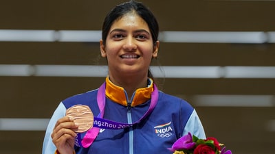 Indian shooter Ashi Chouksey poses for photos with her bronze medal during the presentation ceremony of the women's 50m rifle 3 positions event at the 19th Asian Games (PTI)
