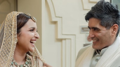 Parineeti Chopra and Manish Malhotra laugh in a candid photo on her wedding day. Parineeti Chopra and Manish Malhotra laugh in a candid photo on her wedding day.