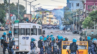 Security personnel fire tear gas as students protest against the killing of two missing students by unknown people in Imphal on Wednesday. (AFP)