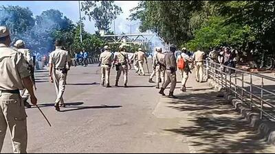 Security personnel stand guard during a protest against the killing of two youths who were allegedly kidnapped in July, in Imphal, Tuesday, Sept. 26 (PTI)