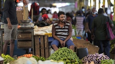 Sri Lanka Economic Crisis: A vender waits for customers at a vegetable market place in Colombo. (AP) Sri Lanka Economic Crisis: A vender waits for customers at a vegetable market place in Colombo. (AP)