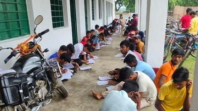 In Bihar, students write exams on roofs and verandahs; pictures go viral (Photosourced ) In Bihar, students write exams on roofs and verandahs; pictures go viral (Photosourced )